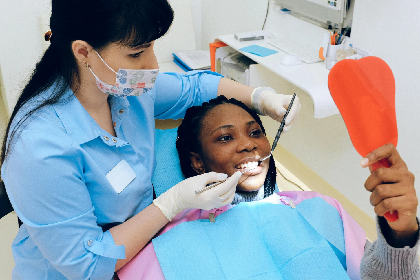 Hygienist performing checkup on patient.